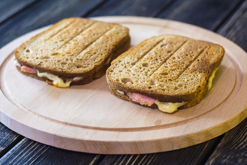 Toasted brown bread with bacon and cheese
