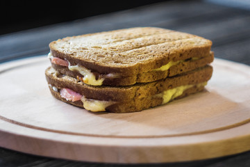 Toasted brown bread with bacon and cheese