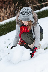 Teenager girl making snowman