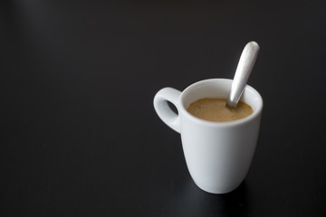 cup of coffee on a black table