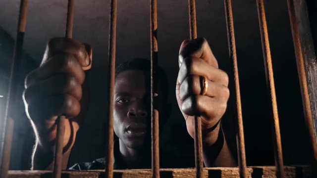 jail, human rights, imprisonment. sad Black african man in the jail