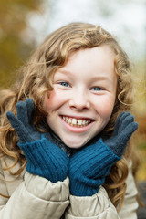 Outdoor portrait of happy blond girl