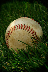 Vintage American Baseball On A Grass Outfield 