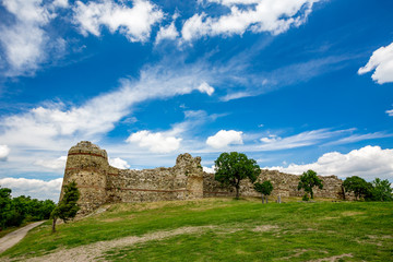 Fototapeta na wymiar Colorful cloudy sky springtime landscape with the remains of ancient Roman fortress, Rhodope Mountains, Southern Bulgaria