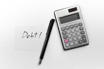 calculator with a pen and paper note with debt word isolated on white background