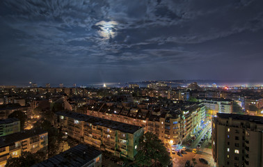 Panorama of Varna in the full moon light , dramatic cityscape.