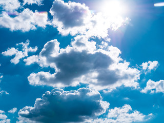 Naklejka na ściany i meble blue sky background with tiny clouds, The sun shines through the clouds.