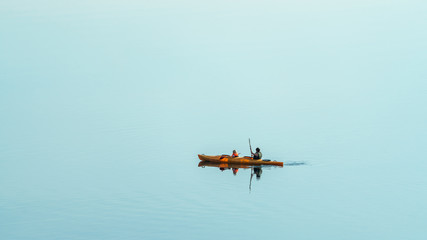Fototapeta na wymiar Two people kayaking on beautiful blue water