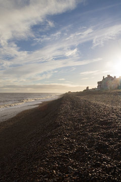 Aldeburgh shingle beach bright sun in winter with lens flare