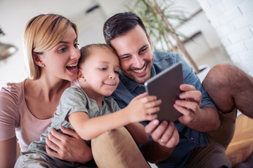 Family using tablet in living room