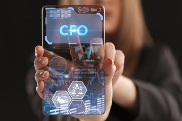 The concept of business, technology, the Internet and the network. A young entrepreneur working on a virtual screen of the future and sees the inscription: CFO