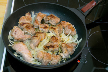 cooking meat on the stove