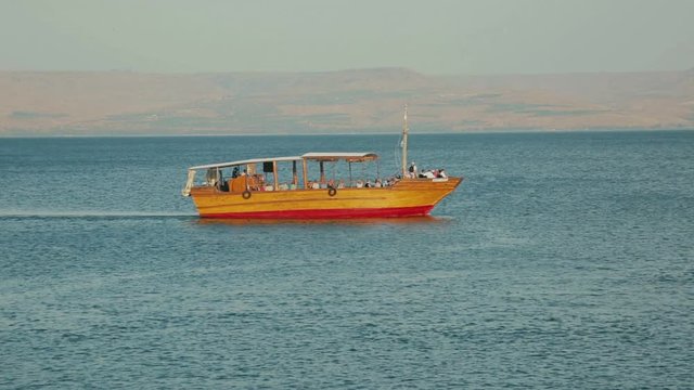 Idyllic scene with a small boat on the Sea of Galilee. Israel, cca. 2015