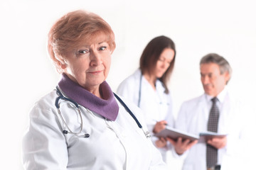 Fototapeta premium adult female doctor therapist on blurred background of colleagues
