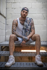 young caucasian tattooed singer rap posing