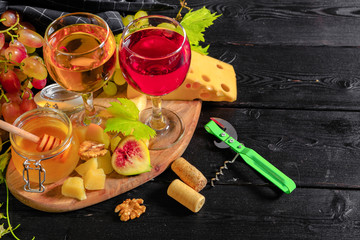 wine with branches of white grapes. On a wooden table.