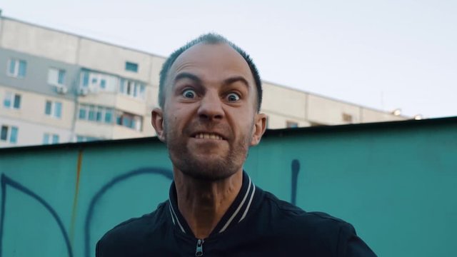 Angry man shouting at someone in the ghetto