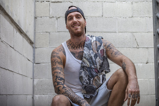 young caucasian tattooed singer rap posing