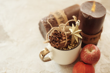 Festive composition mug with cinnamon, apples, candles and Christmas decoration