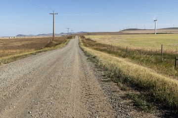 Fototapeta na wymiar Country road and wind turbines near Lunbreck, Alberta