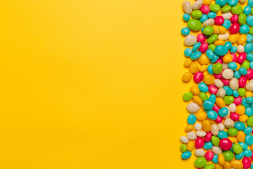 colored candies on yellow background