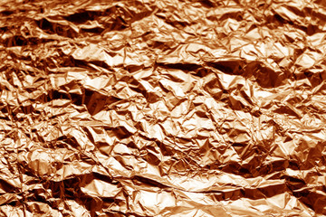 Metal foil texture in orange tone.