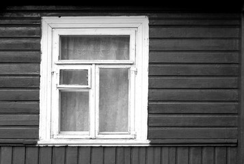 Old window of wooden house in black and white.