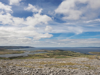 Fototapeta na wymiar View on Galway bay and Atlantic ocean from Burren national park, sunny day with cloudy sky.