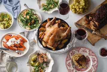 Big festive dinner with roasted chicken and various garnishing. Overhead view, celebration concept