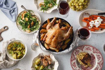 Big festive dinner with roasted chicken and various garnishing. Overhead view, celebration concept