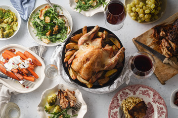 Big festive dinner with roasted chicken and various garnishing. Overhead view, celebration concept