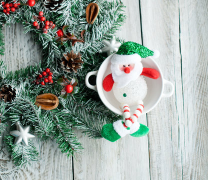 Christmas wreath and snowman, greeting card and Christmas background on light background.