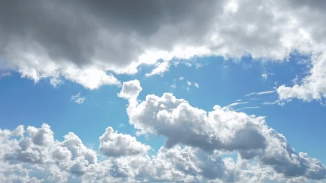 4k time lapse footage of dark storm clouds parting to show blue sky and bright sunshine