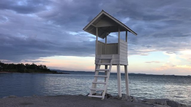 lifeguard tower on the beach. Wood white pavilion at shore.