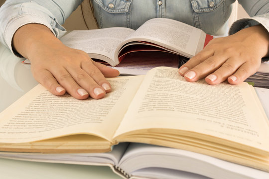 Education and concept. Female student hand on books and desk, studying. Woman.