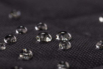 Water drops on waterproof black fabric - 227960356