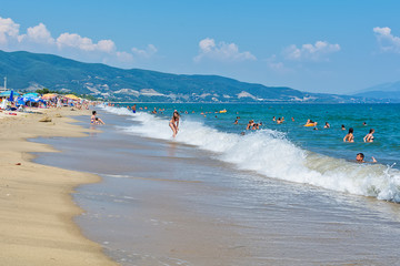 Fototapeta premium Asprovalta, Greece - August 20, 2018: Asprovalta and New Vrasna resort, Asprovalta beach. Sea view to Asprovalta at the foot of the green hills.