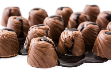 pieces of bonbons covered with melted chocolate isolated on white background