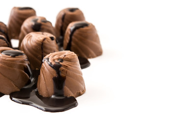 pieces of bonbons covered with melted chocolate isolated on white background. Copyspace