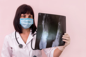 Doctor traumatologist with foot x-ray of a patient