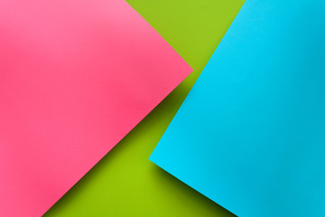 Blue, green and pink pastel colored paper background. Volume geometric flat lay. Top view. Copy space