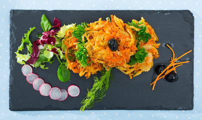 Tasty fried  vegetarian carrots cutlets with greens served at plate