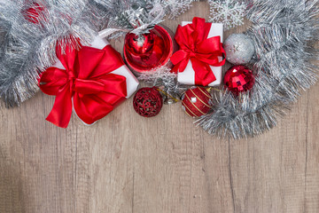 Present box with garland on wooden table, top view