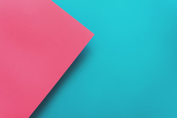 Blue and pink pastel color papered background. Volume geometric flat lay. Top view. Copy space. Toned
