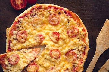 Homemade spicy pizza with chicken and tomato.