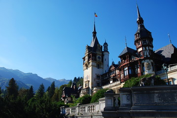 Fototapeta premium Peles Castle in summer sorrounded by Carpathian Mountains, Romania