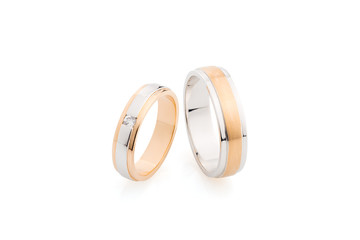 Pair of pink gold and white gold wedding rings isolated on white background