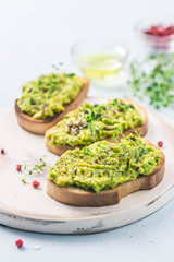 Smashed avocado sea salt and herbs toast. Selective fcous, space for text.