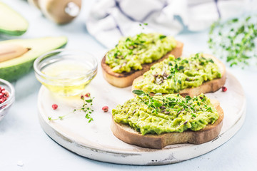Smashed avocado sea salt and herbs toast. Selective fcous, space for text.