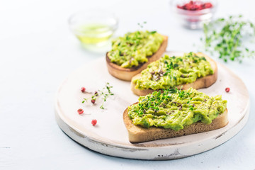 Smashed avocado sea salt and herbs toast. Selective fcous, space for text.